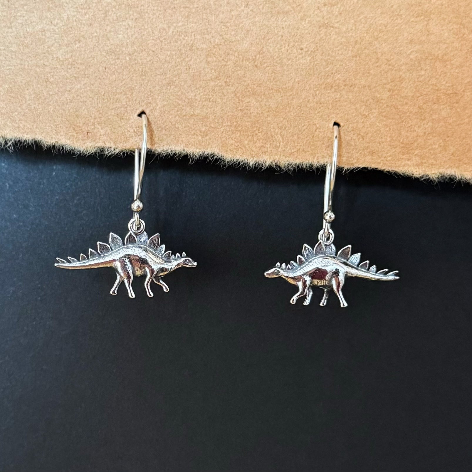 Silver earrings stegosaurus